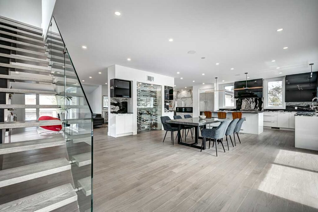 Homeowner reviewing comparable property information and a pricing worksheet at a dining table.