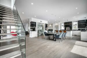Homeowner reviewing comparable property information and a pricing worksheet at a dining table.